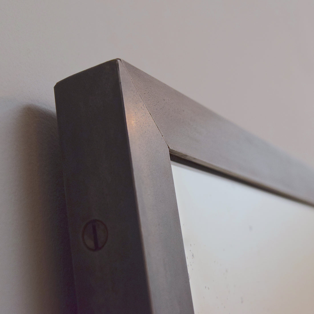 Steel angle framed antiqued mirror by Rough Old Glass