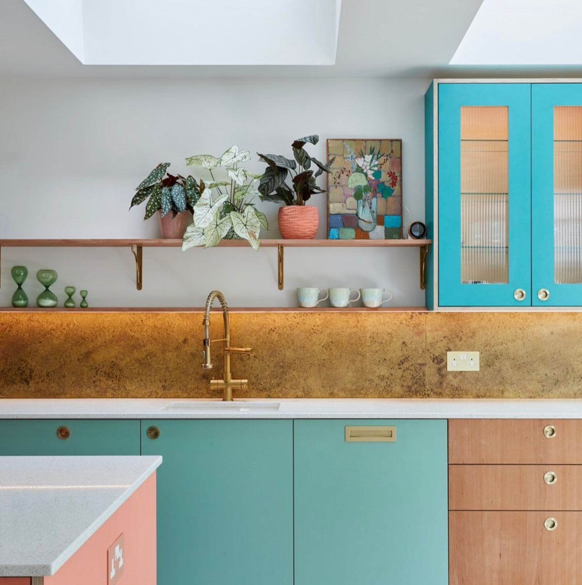 Rose Marbled Antiqued Brass splashback in a colourful kitchen with teal cabinets